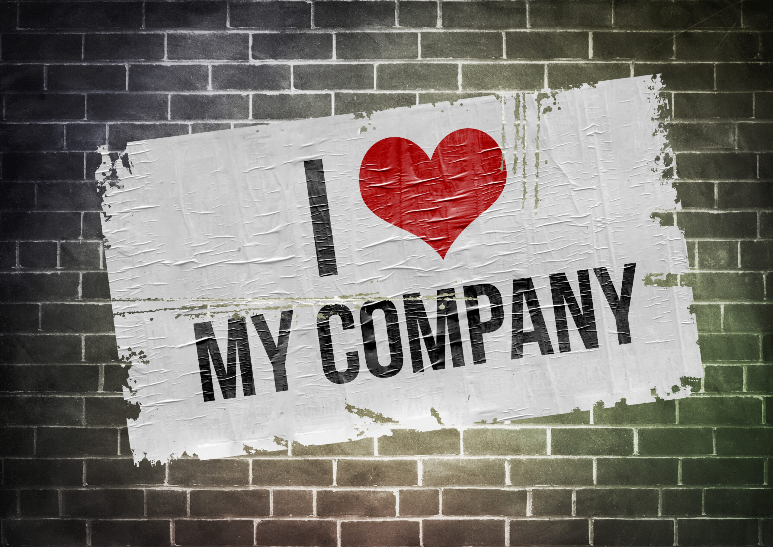 Graffiti-style poster on brick wall stating 'I love my company' with a red heart symbolizing passion for ServiceNow roles.