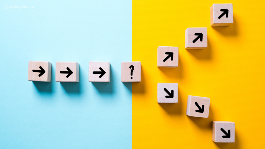 Wooden blocks showing arrows in a straight line ending in a question mark, then splitting into paths that rise and fall